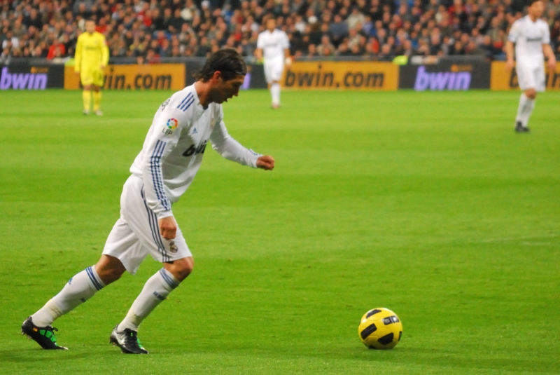 Sergio Ramos from Real Madrid kicking the ball on the pitch