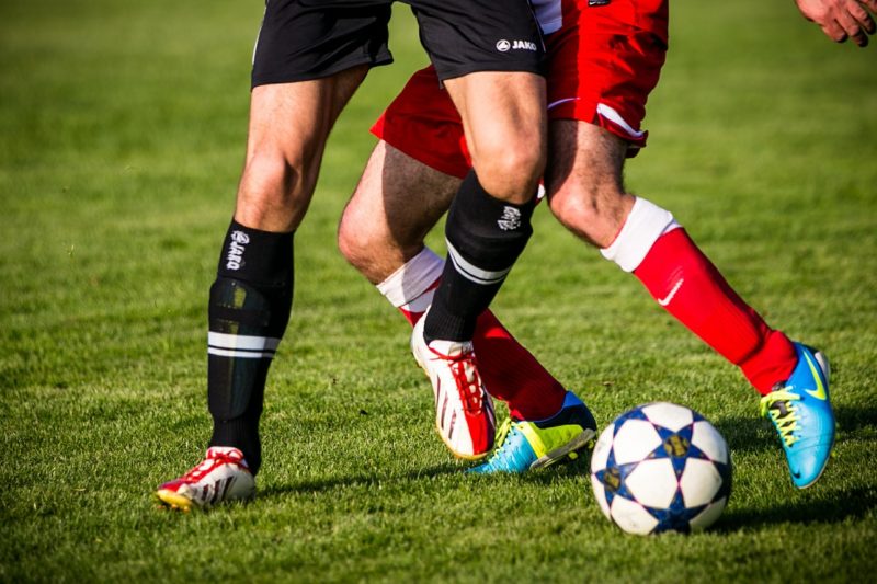 Players dribling on a pitch 