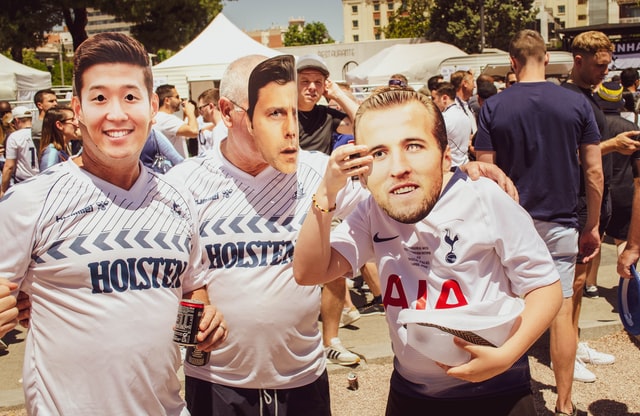 Fans wearing football parleys' masks