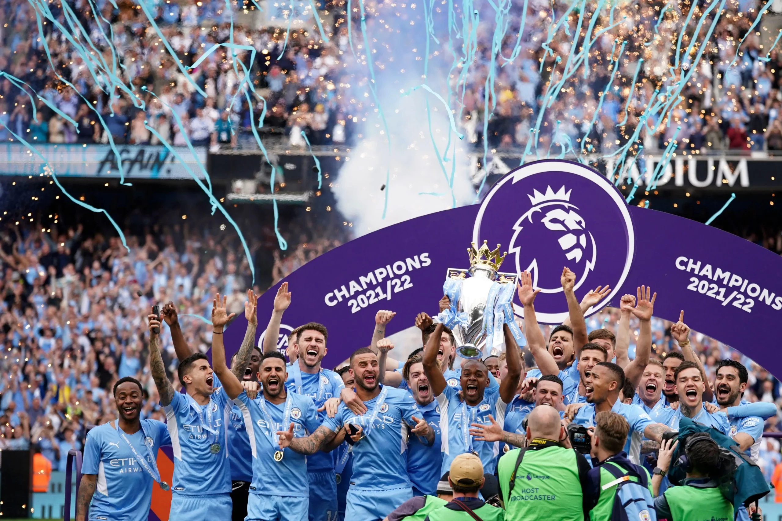 Manchester City players celebrate with trophy after winning the 2022 English Premier League title