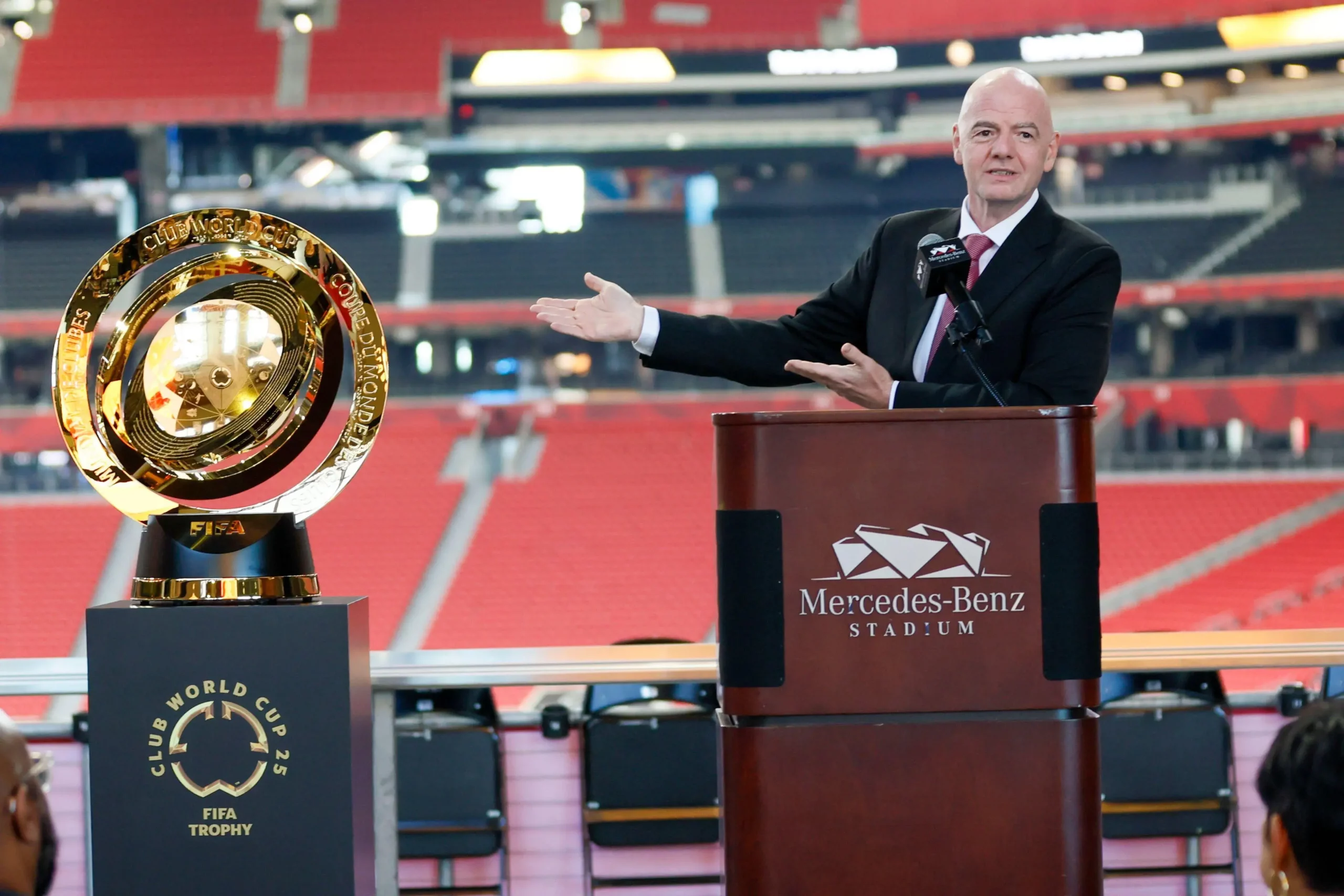 FIFA President Gianni Infantino gestures toward the FIFA World Cup soccer trophy during a news conference